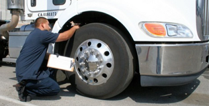 Semi-truck tire checked for safety